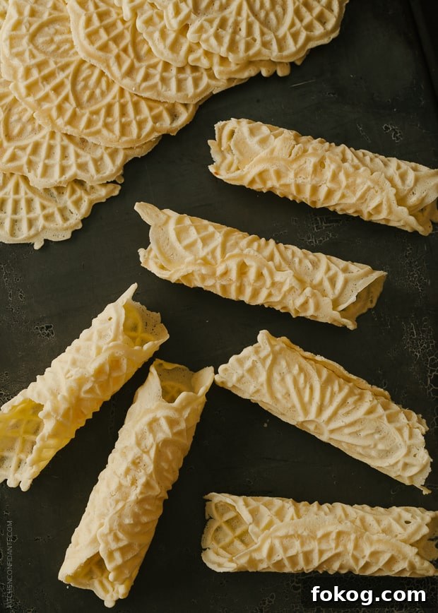 Nutella and Berry-Filled Pizzelle Waffle Cookies 4 Rolled Pizzelle on a dark background.