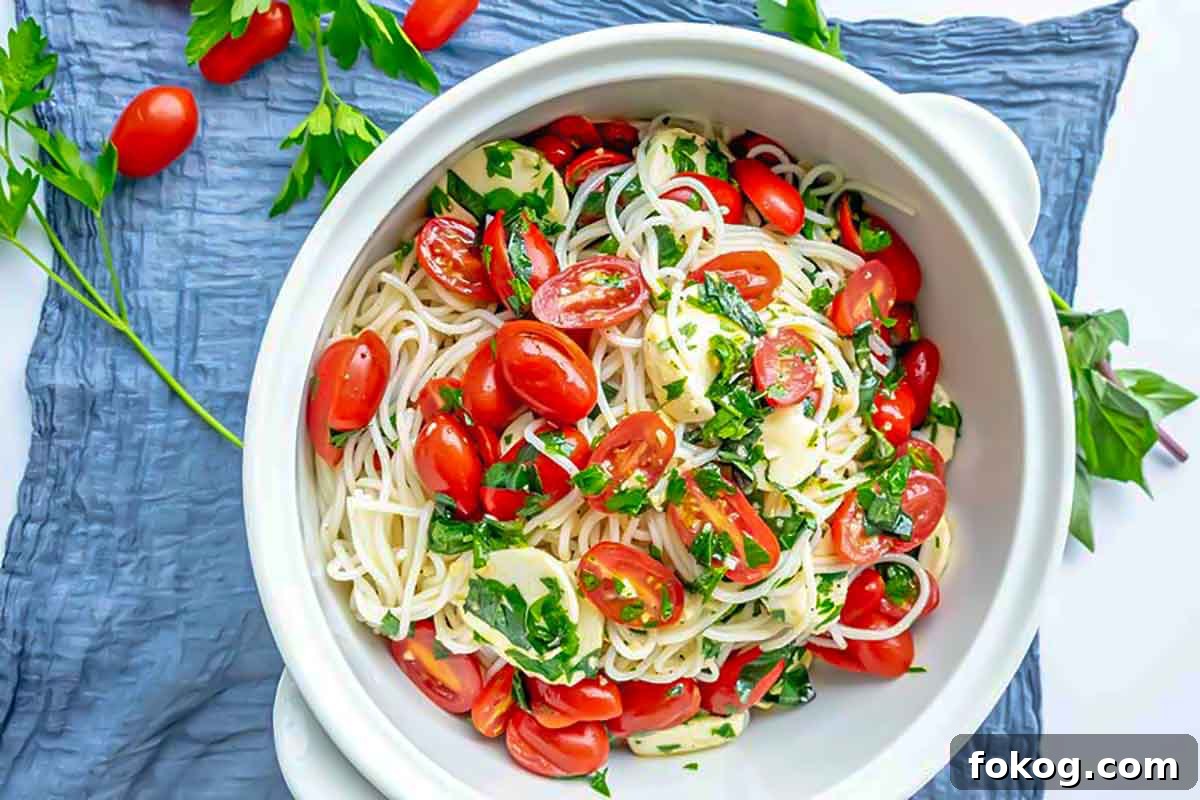 gluten free vegetarian Italian pasta salad with fresh tomatoes and basil in a bowl