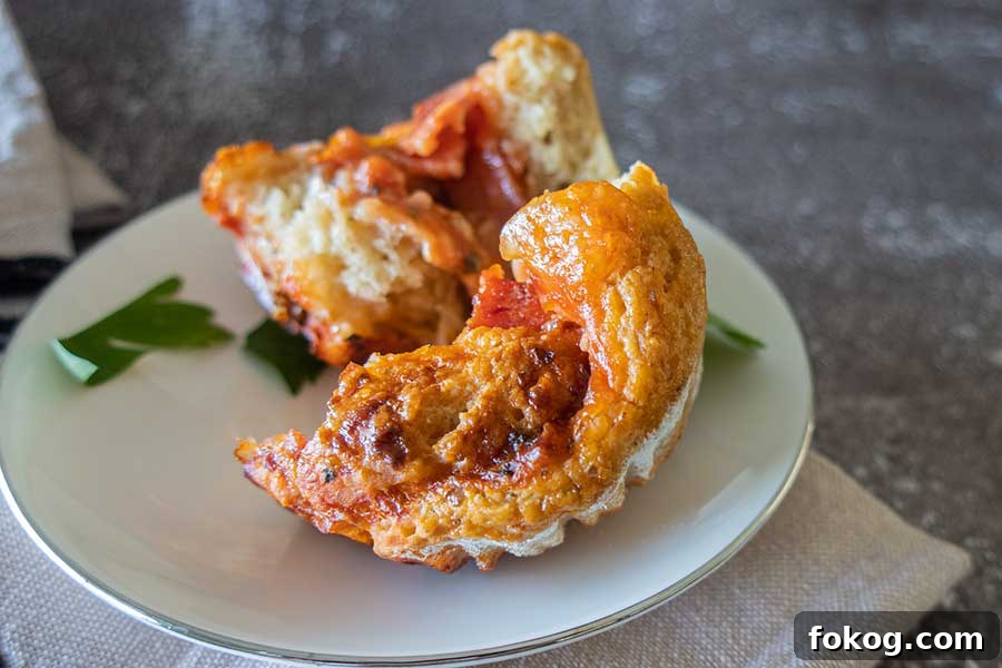 ChatGPT said: Gluten-free pizza roll, sliced in half to reveal gooey melted cheese and savory pepperoni inside.