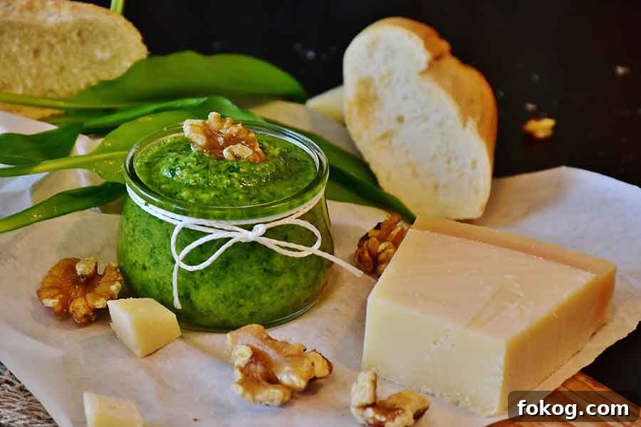 WALNUT PESTO in a jar with a side of parmesan and slice of Italian bread