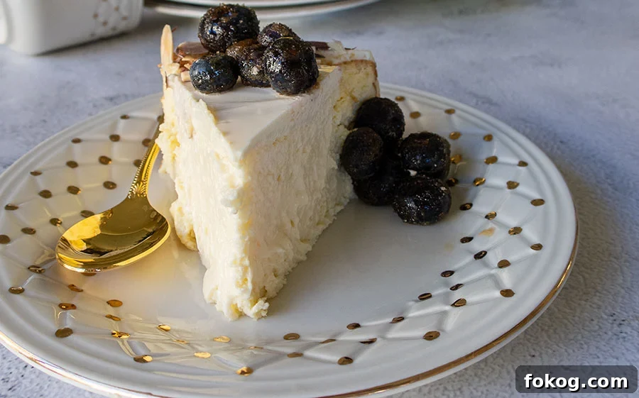 a slice of creamy amarettto cheesecake topped with fresh blueberries on a plate
