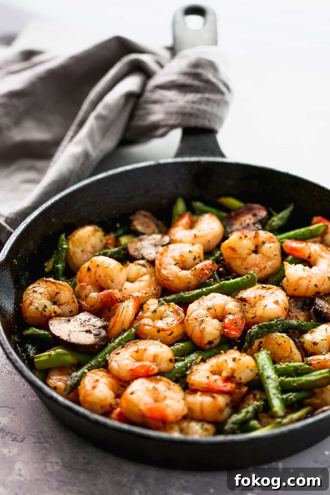 Garlic Butter Shrimp with Asparagus Recipe for Quick Weeknights 2 Sauteed shrimp, asparagus and mushrooms in a skillet.