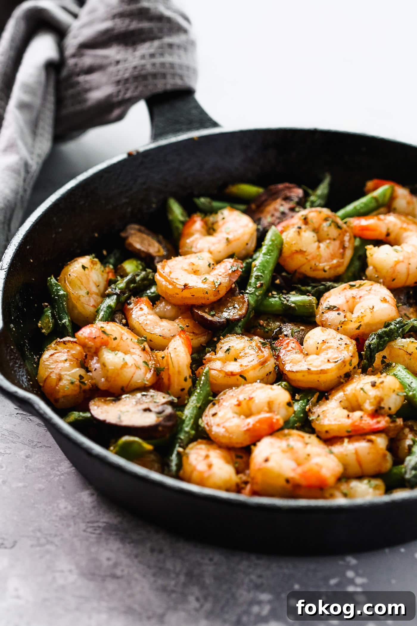 Garlic Butter Shrimp with Asparagus Recipe for Quick Weeknights 4 Sauteed shrimp, asparagus and mushrooms in a skillet.