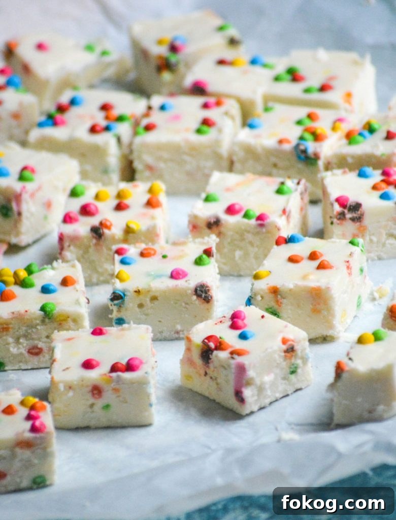rainbow chip fudge shown cut into squares and laid out on parchment paper