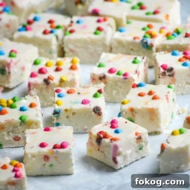 rainbow chip fudge shown cut into squares and laid out on parchment paper