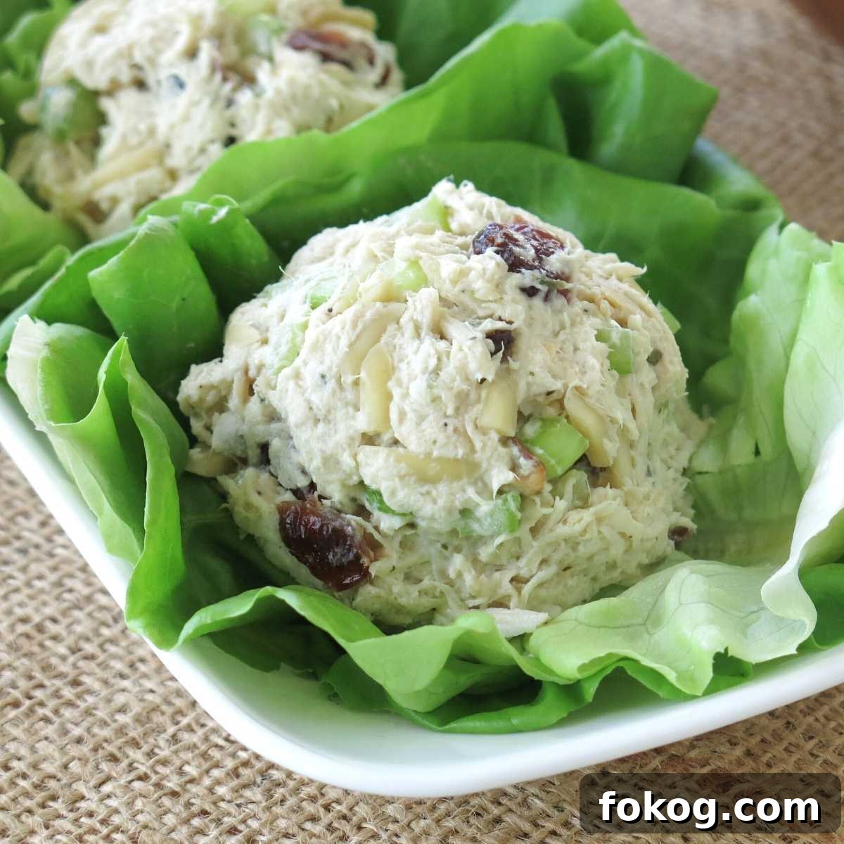 A scoop of chicken salad on a lettuce leaf.