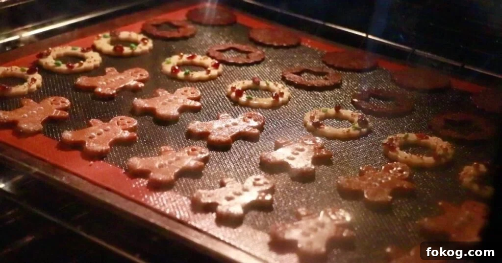 holiday cookies on a sheet tray in the oven