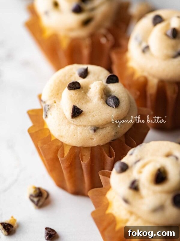 Small batch chocolate chip cookie dough cupcakes on a white marbled background.