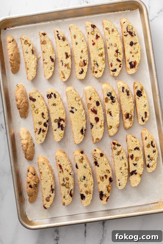 Cranberry, Orange & Pistachio Biscotti Recipe 6 Sliced biscotti on a sheet pan