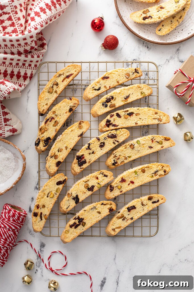 Cranberry, Orange & Pistachio Biscotti Recipe 7 Cranberry Orange biscotti on a cooling rack.