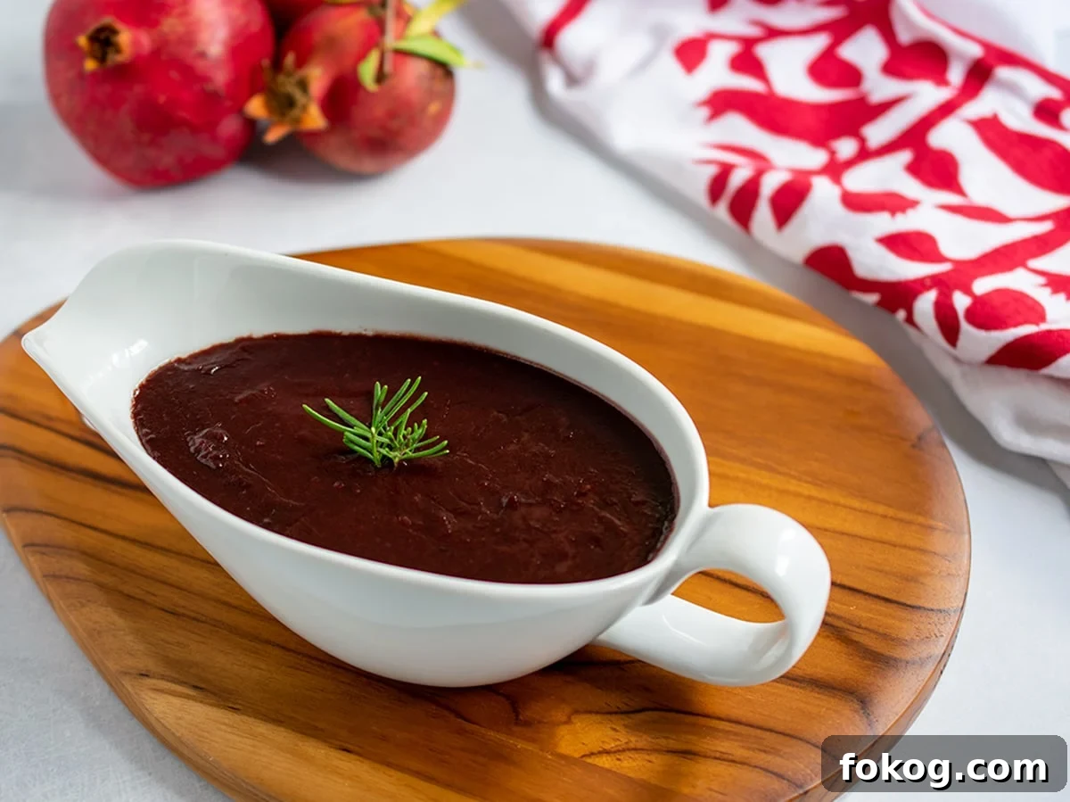 Pomegranate-Port Gravy with Rosemary for Roasts and Poultry 12 Pomegranate gravy in a gravy boat ready to serve.