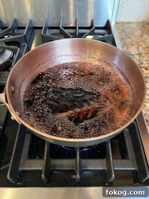 Pomegranate-Port Gravy with Rosemary for Roasts and Poultry 6 Pomegranate gravy mixture almost done reducing.