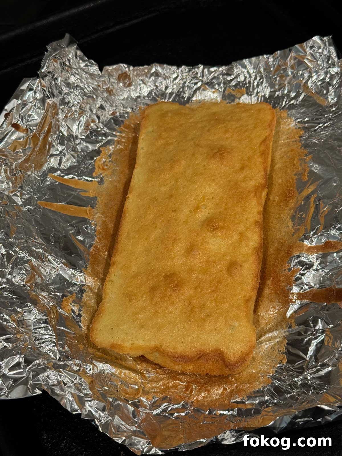 Olive oil sponge cake spread in a thin layer and baked in a foil lined loaf pan.