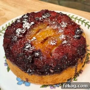 Olive Oil Upside Down Fruit Cake topped with mixed berries and peaches.