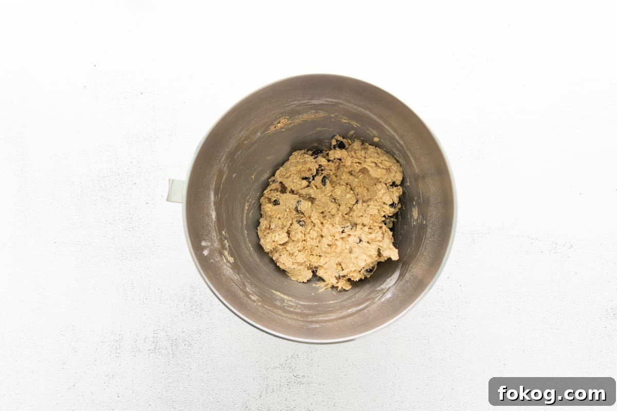 cookie dough in a mixing bowl on a white background.