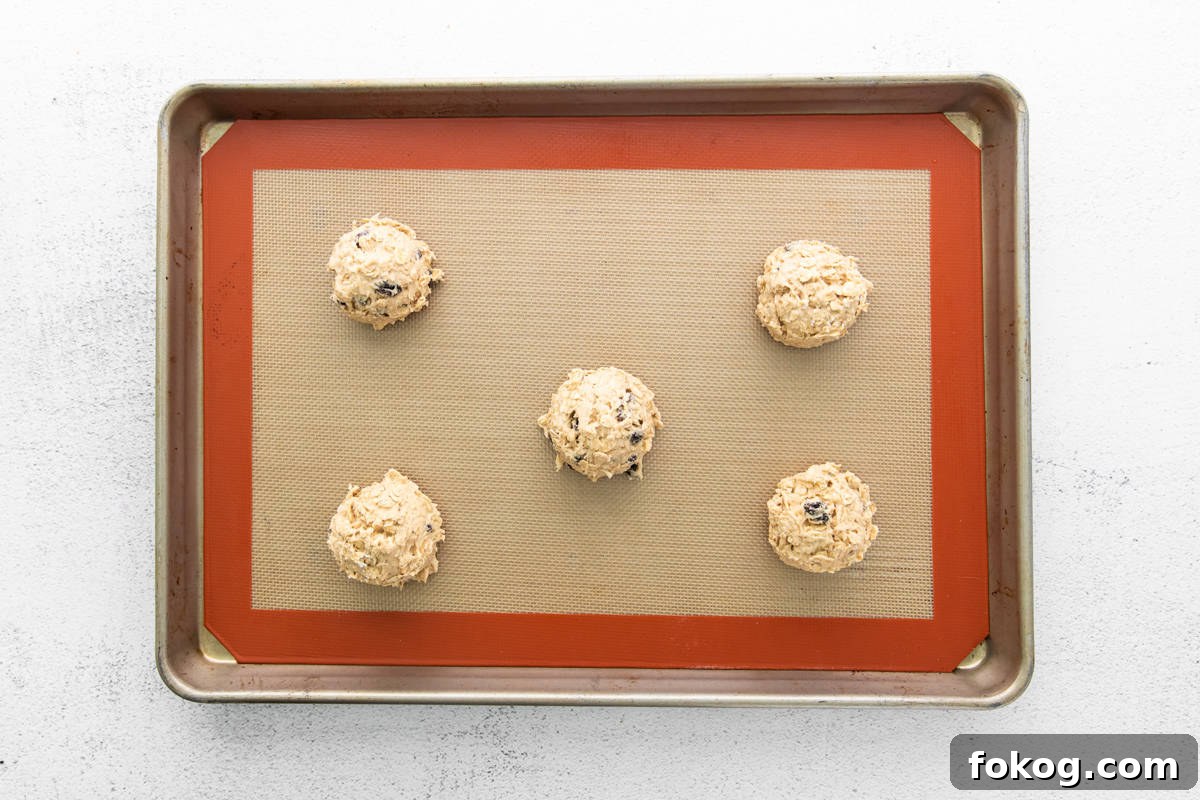balls of cookie dough arranged on a baking tray.