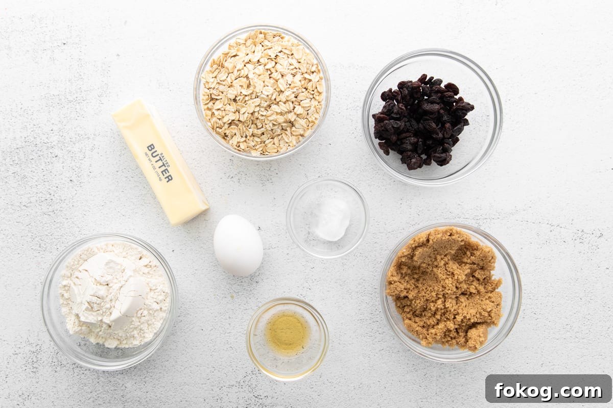 the ingredients for oatmeal raisin cookie recipe are in bowls on a white background.