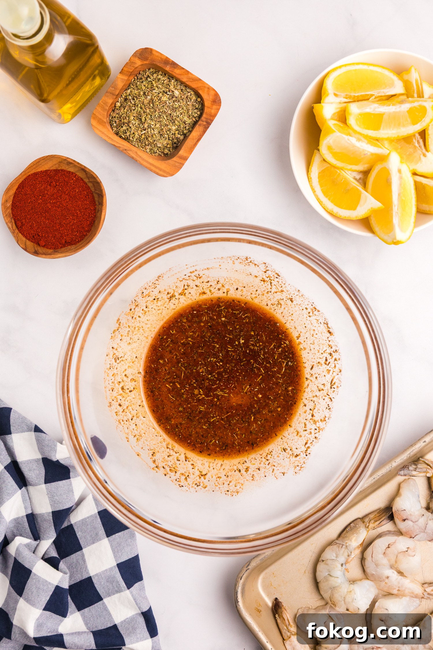 Perfect Grilled Shrimp Recipe for Juicy, Flavorful Results 5 The spice mixture in the glass bowl fully combined into a marinade with a deep reddish-brown color.