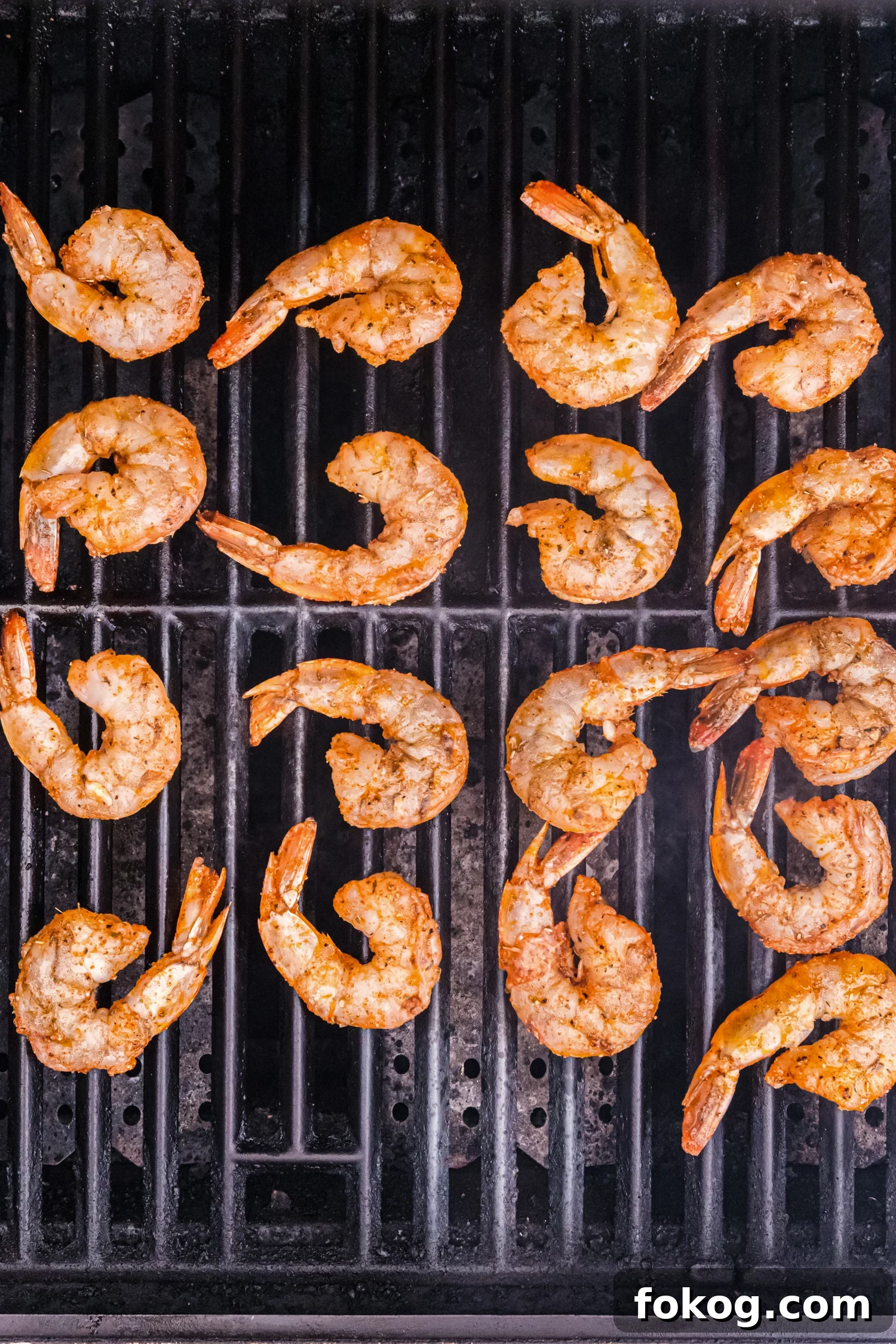 Perfect Grilled Shrimp Recipe for Juicy, Flavorful Results 8 Marinated shrimp placed on a hot grill, beginning to cook with a light sear.