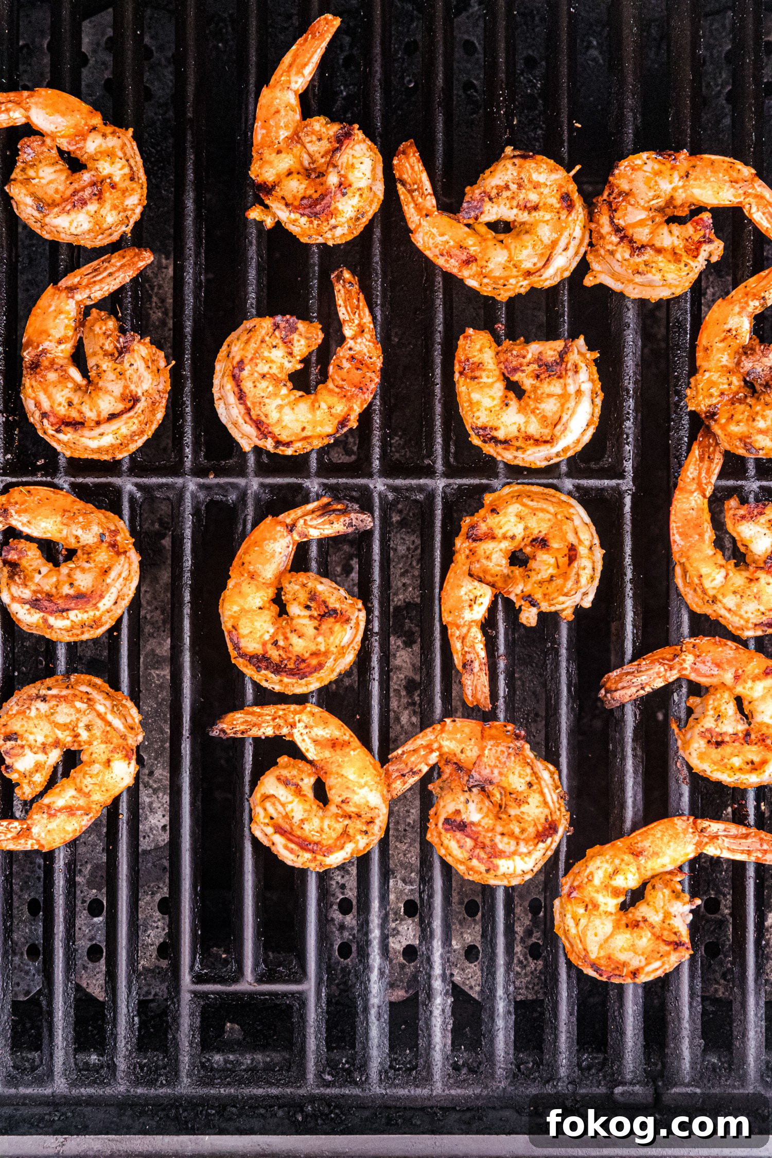 Perfect Grilled Shrimp Recipe for Juicy, Flavorful Results 9 Grilled shrimp showing more pronounced grill marks and browning, indicating they are nearly done.