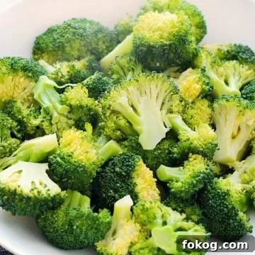 Perfectly Steamed Broccoli: Simple Steps for Tender, Crisp Results 7 Steamed Broccoli in a white bowl.