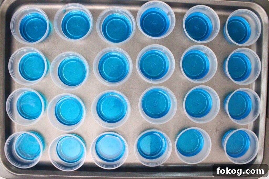 pour blue jello mixture into the base of jello cups
