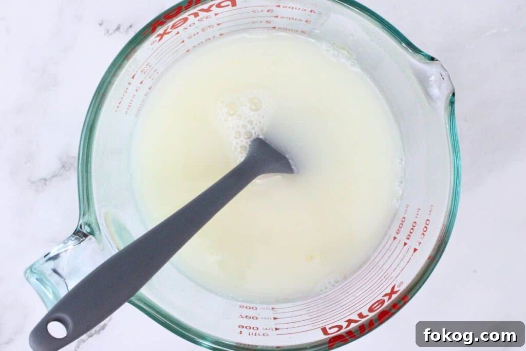 mix unflavored gelatin with boiling water then stir in coconut rum and sweetened condensed milk