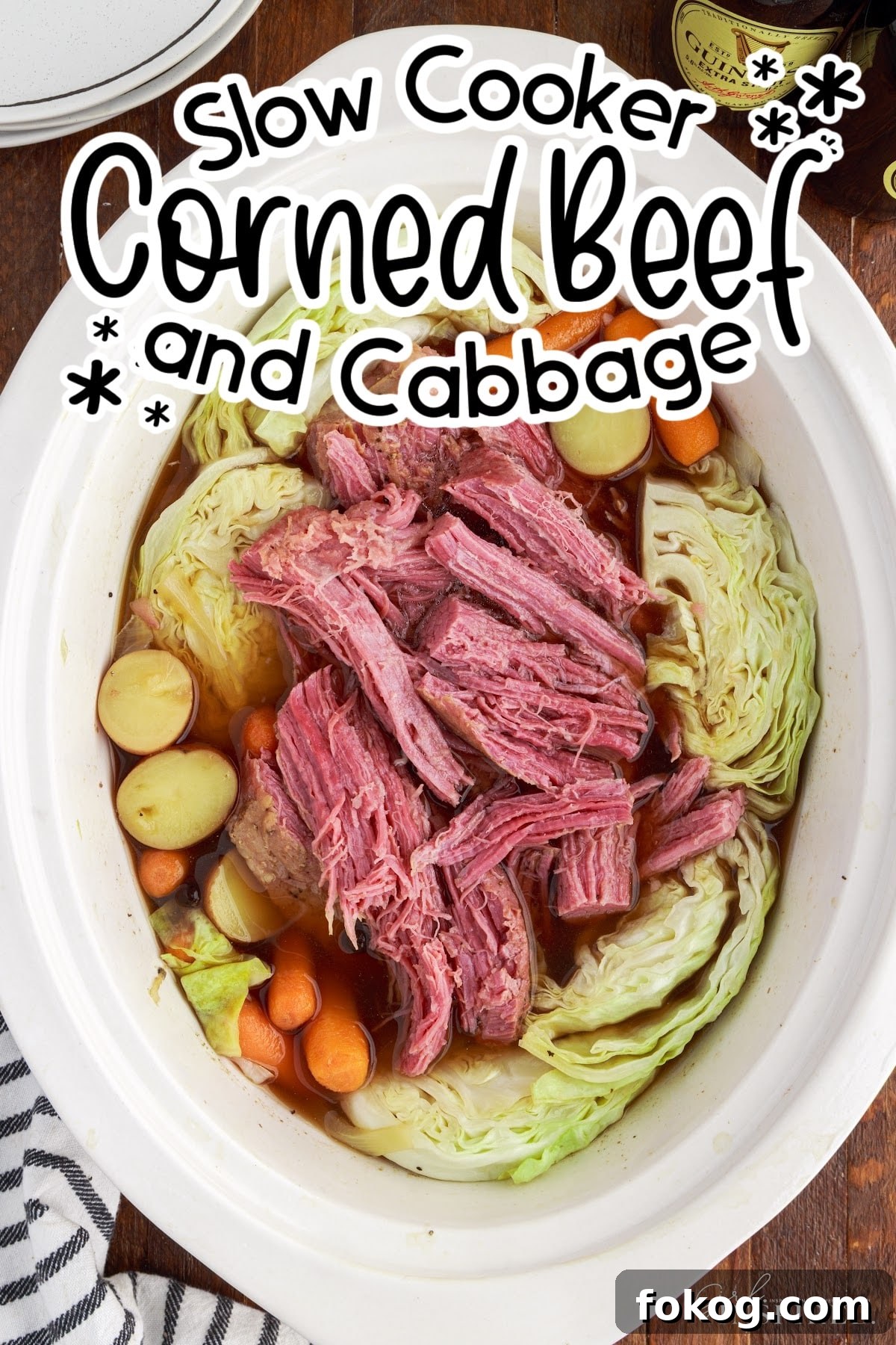 Top view of Slow Cooker Corned Beef and Cabbage in a crock pot, showing the beef, cabbage and potatoes, with text overlay.