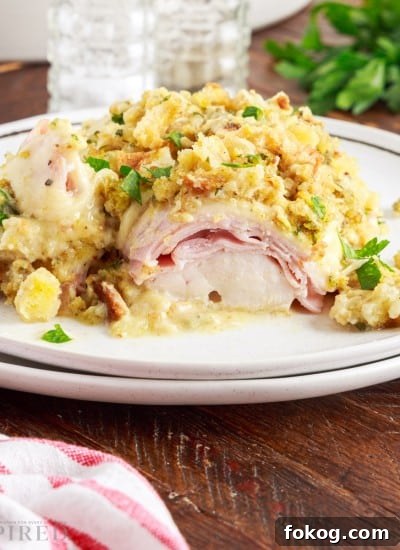 Two stacked plates with crockpot chicken cordon bleu.