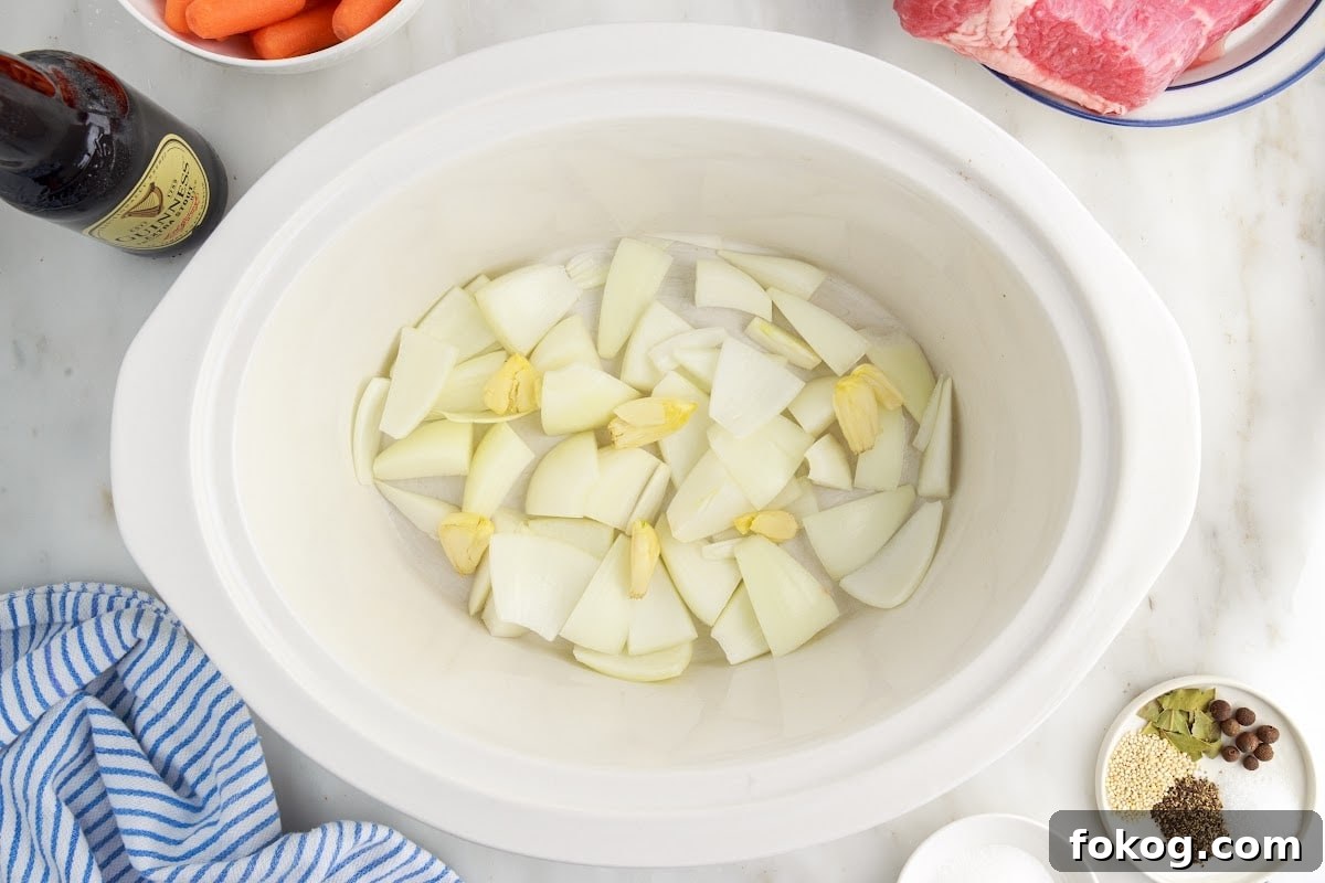 Place the sliced onions and garlic on the bottom of the crock pot.