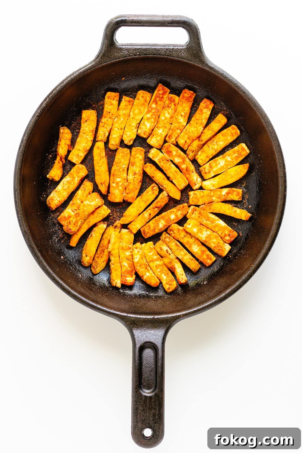 Grilled Halloumi Fajitas with Peppers and Lime crema 8 Fried halloumi strips in a cast iron skillet.