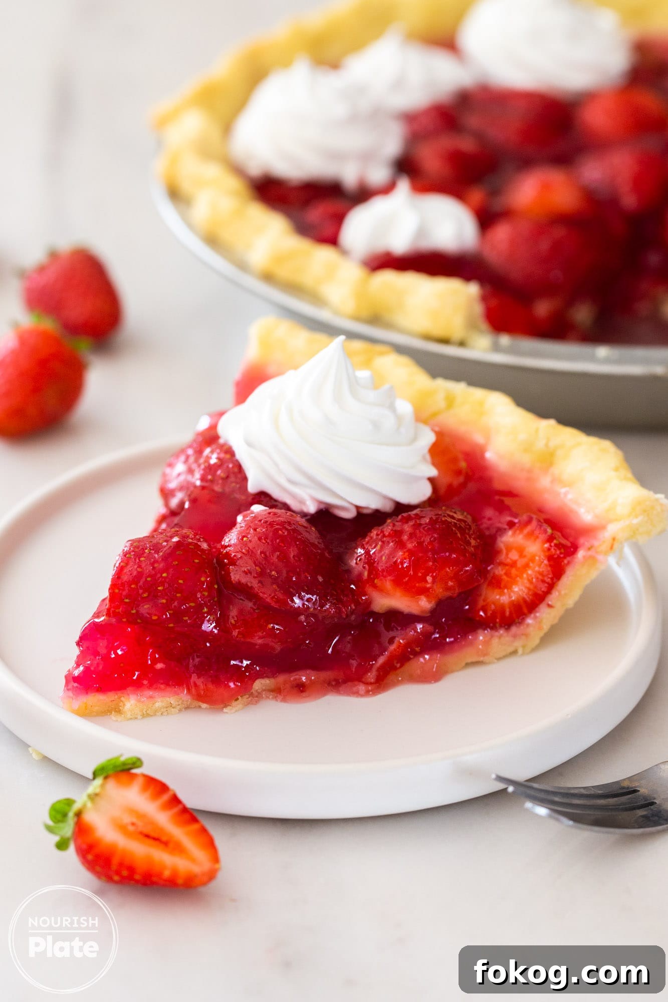 Fresh Strawberry Pie Recipe: Classic No-Bake Summer Dessert 2 A slice of fresh strawberry pie on a small white plate, with whipped cream on top