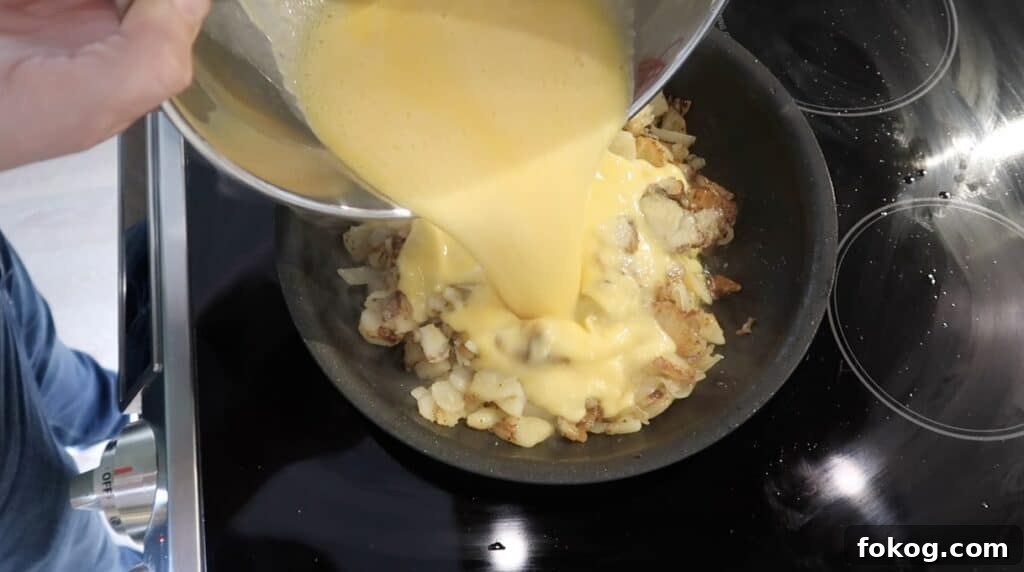 Spanish Omelette Scramble Recipe: Quick Tortilla Española Twist 16 pouring eggs into skillet