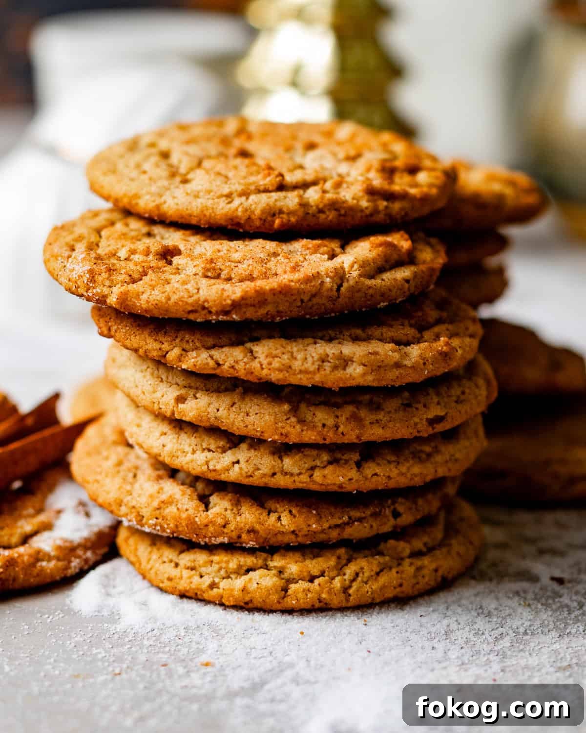 brown butter snickerdoodle cookies stacked on top of each other.