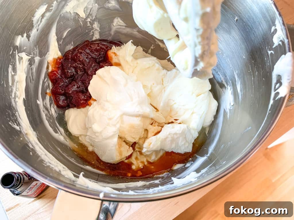 A mixing bowl filled with cream cheese and guava jelly