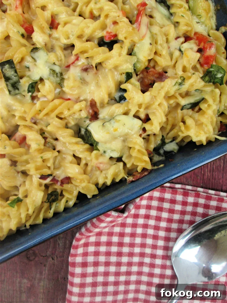 The fusilli pasta bake with bacon and zucchini in a serving dish