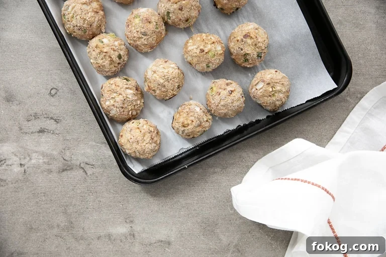 Fully cooked meatballs on tray ready to place in the freezer