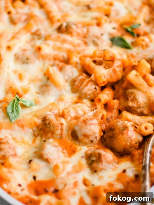 Meatball casserole with pasta and melted cheese.