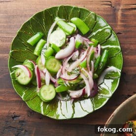 Sugar snap pea salad on green plate.