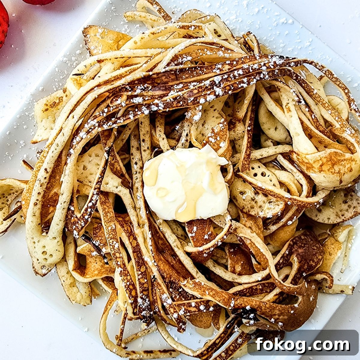 TikTok Viral Spaghetti Pancakes Recipe You Have to Try 7 above shoot close up of pancake spaghetti with butter on top