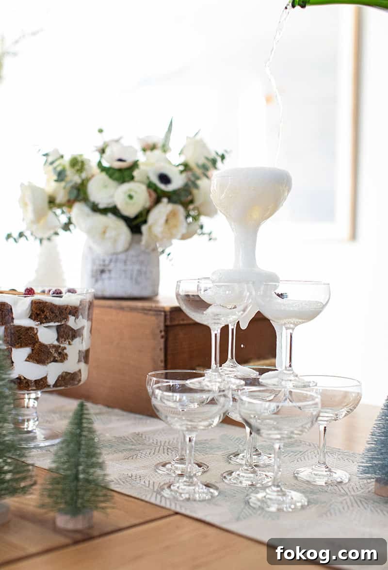 Champagne coupe glasses stacked with Champagne being poured over the top.