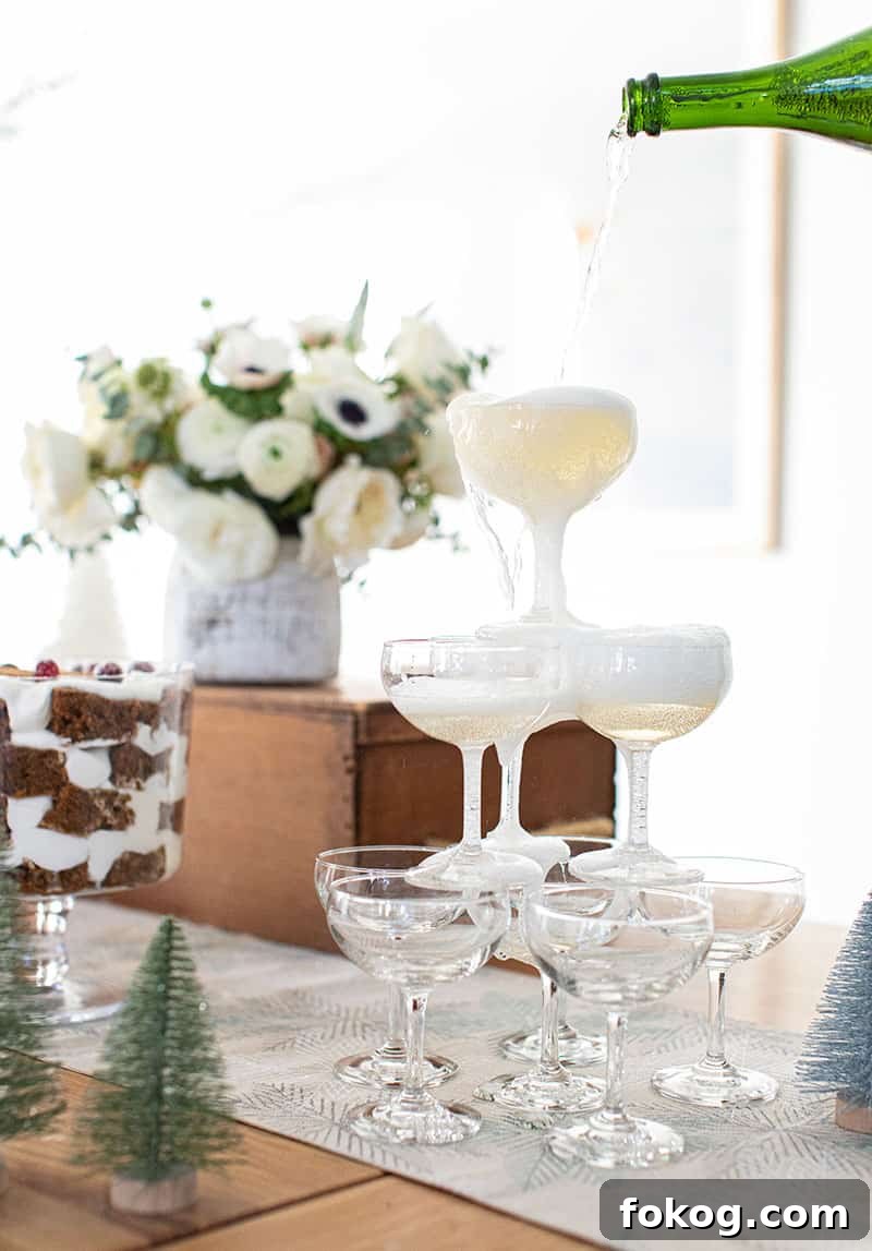 Bottle of Champagne being poured over the coupe glasses.