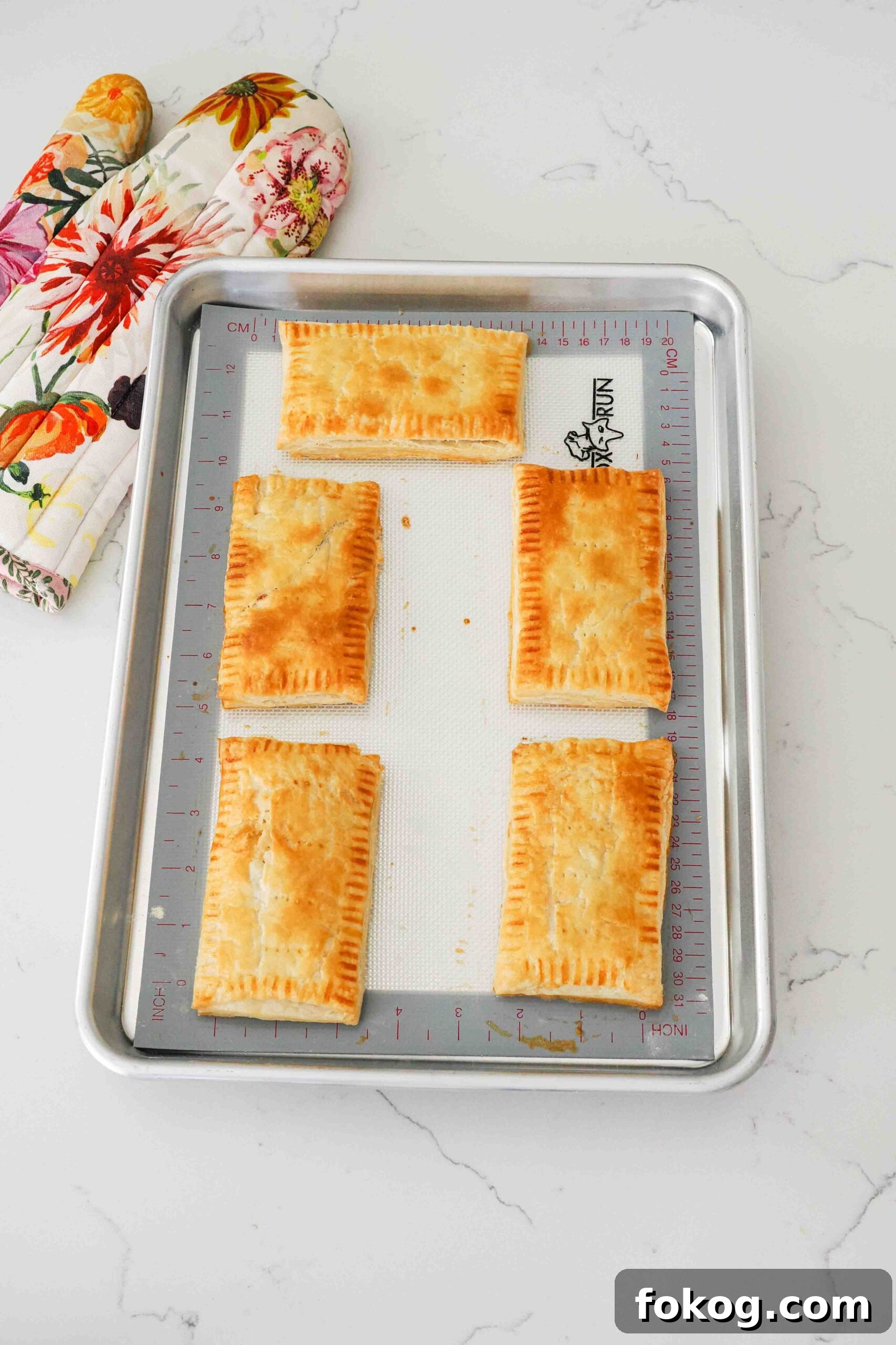 Baked homemade toaster strudels on a baking sheet.