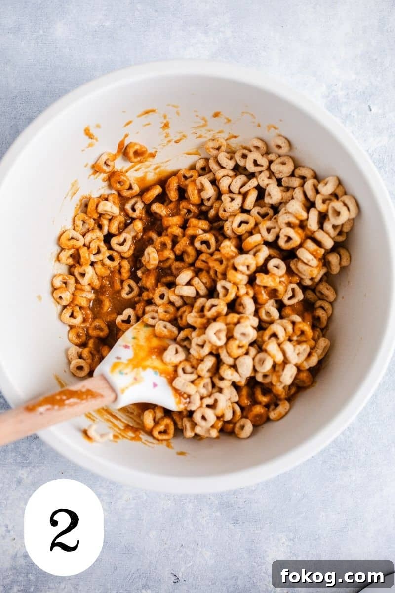 3-Ingredient Peanut Butter Cereal Energy Bites 5 Cereal and peanut butter in a mixing bowl.