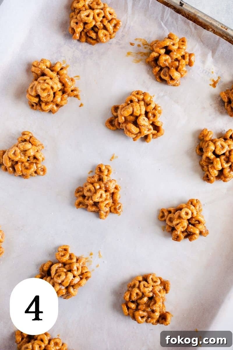 3-Ingredient Peanut Butter Cereal Energy Bites 7 Mounds of peanut butter balls on a baking sheet.