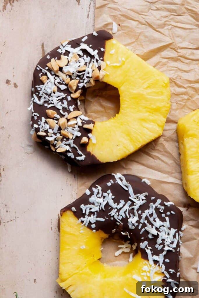 Chocolate-Covered Pineapple Recipe: Sweet Tropical Treat in Minutes 10 chocolate covered pineapple rings with shredded coconut and crushed peanuts
