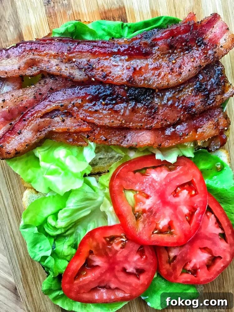The BLT ingredients on two slices of sourdough bread.