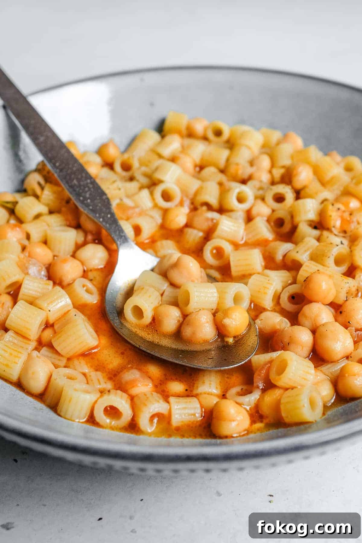 Pasta e Ceci – Italian Pasta with Chickpeas | cookeatworld.com a bowl of Italian pasta e ceci with a spoon