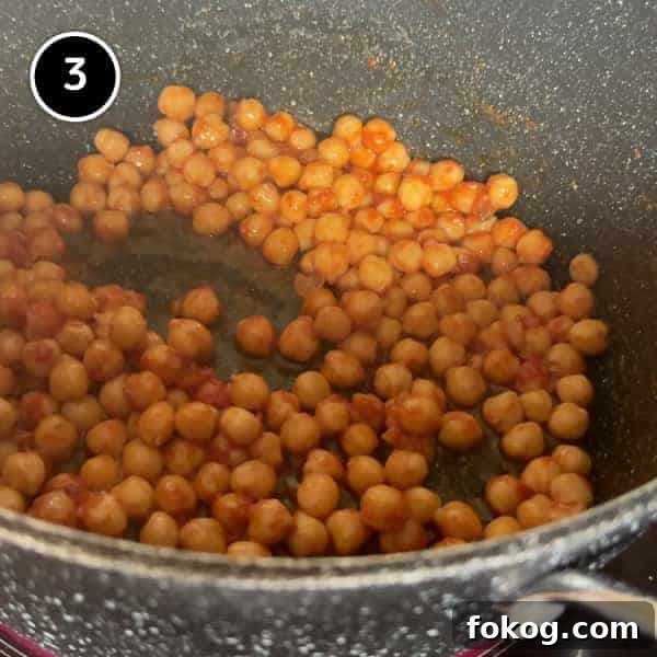 Pasta e Ceci – Italian Pasta with Chickpeas | cookeatworld.com sauteeing the chickpeas in the garlic and tomato paste