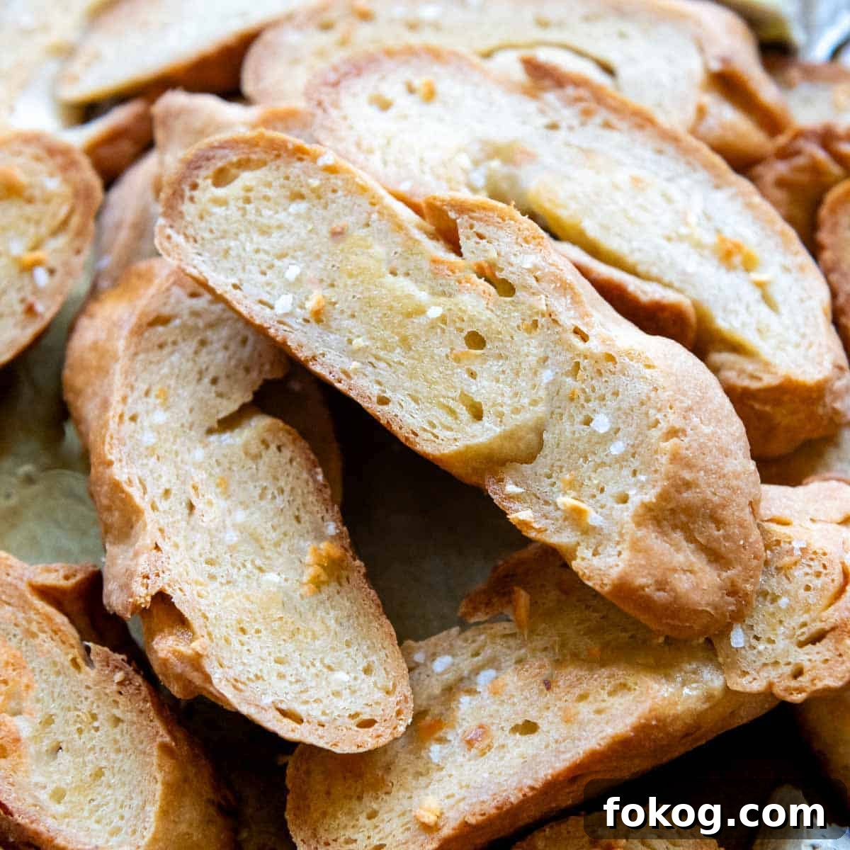 a stack of crostini toast with salt sprinkled on.